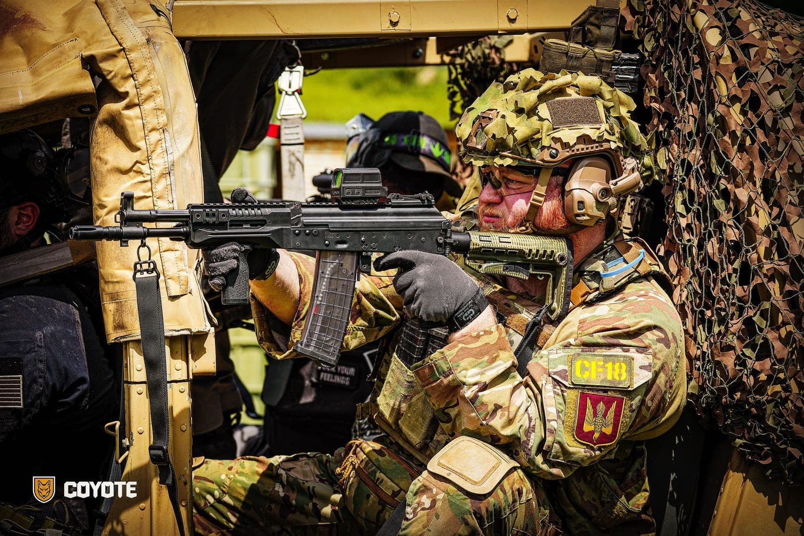 Two Coyote Force teammates in a vehicle on a game day