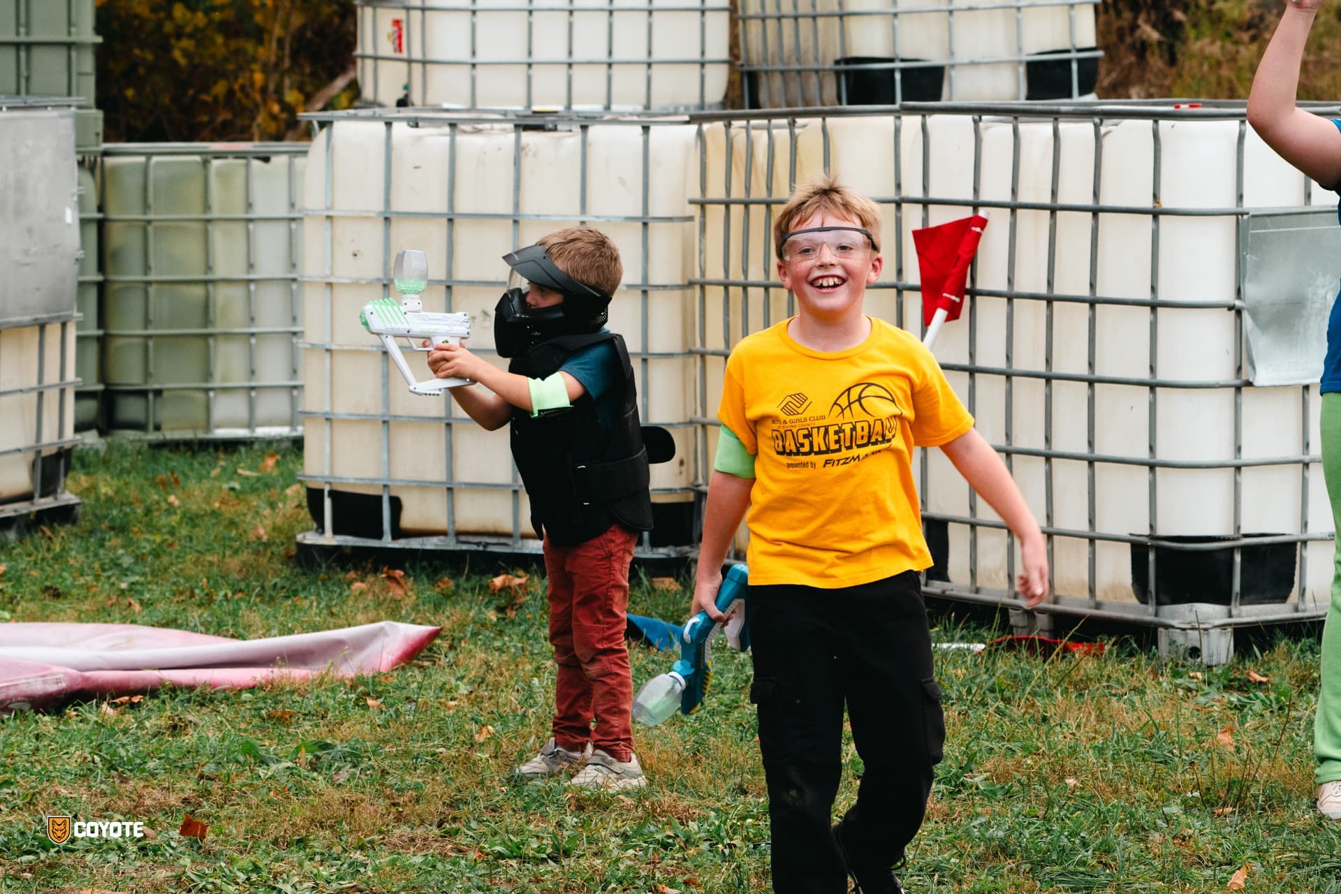 Kids smiling with gellyball blasters at Coyote Field