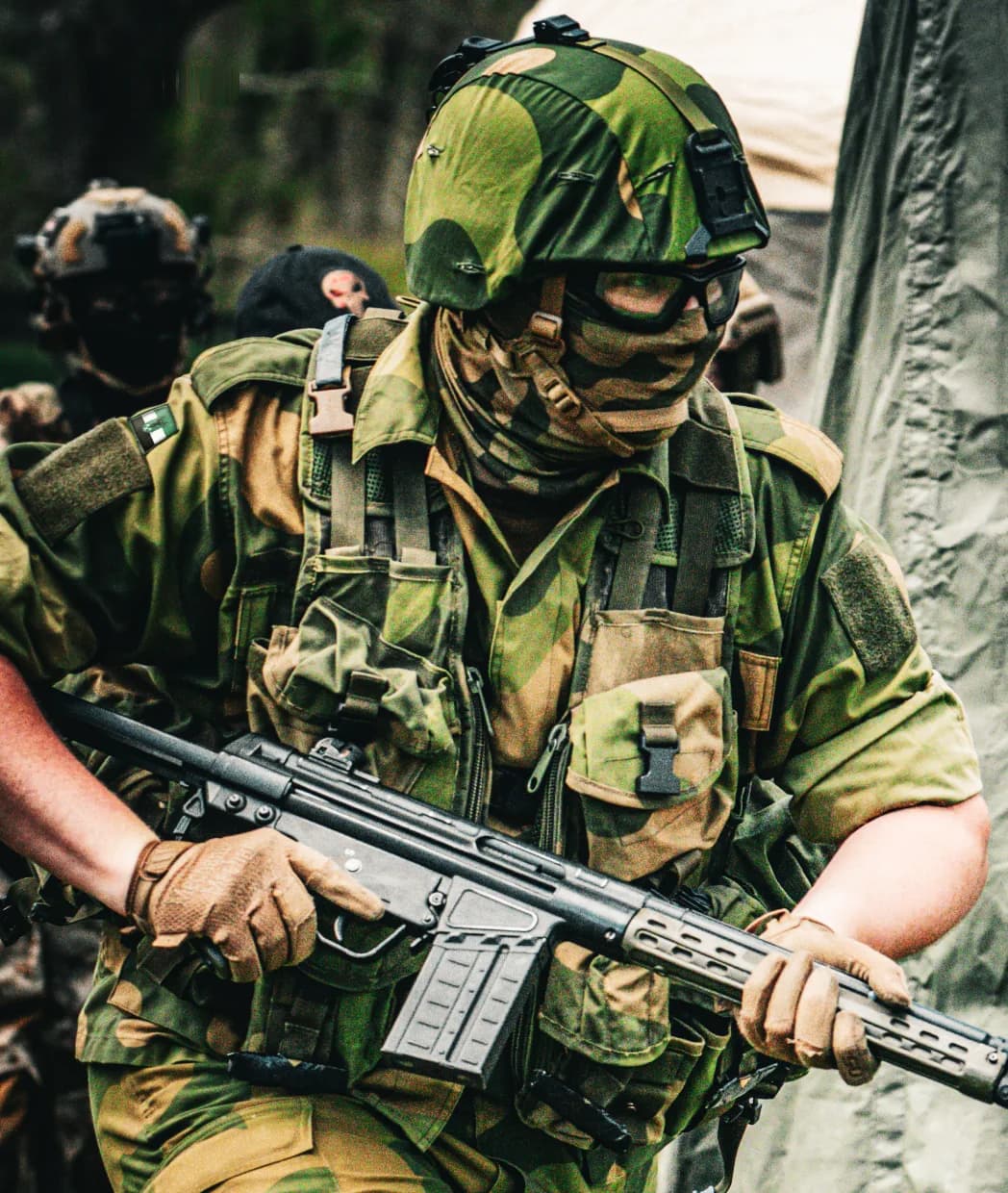 Frontier Coalition soldier in green camouflage with a rifle
